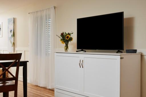 The spacious lower-level accessory unit offers exceptional versatility with its own private entrance, full kitchen with stainless steel appliances, full bath, and separate laundry.