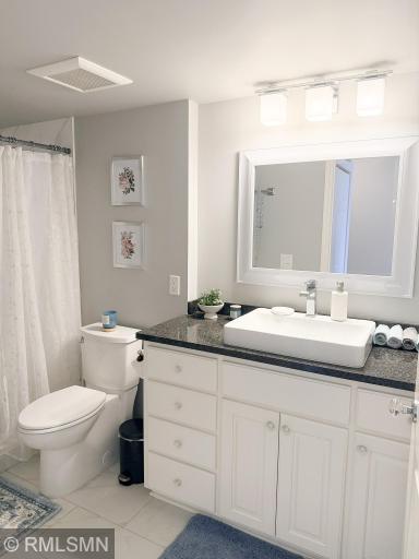 Beautiful bathroom with tiled floors and granite counter top vanity!
