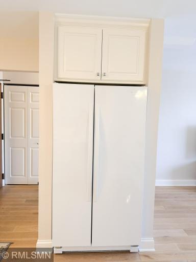 White kitchen appliances and nice sized built-in refrigerator!
