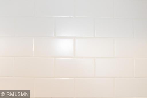 Gorgeous enameled subway tile in the kitchen makes it for easy cleaning!