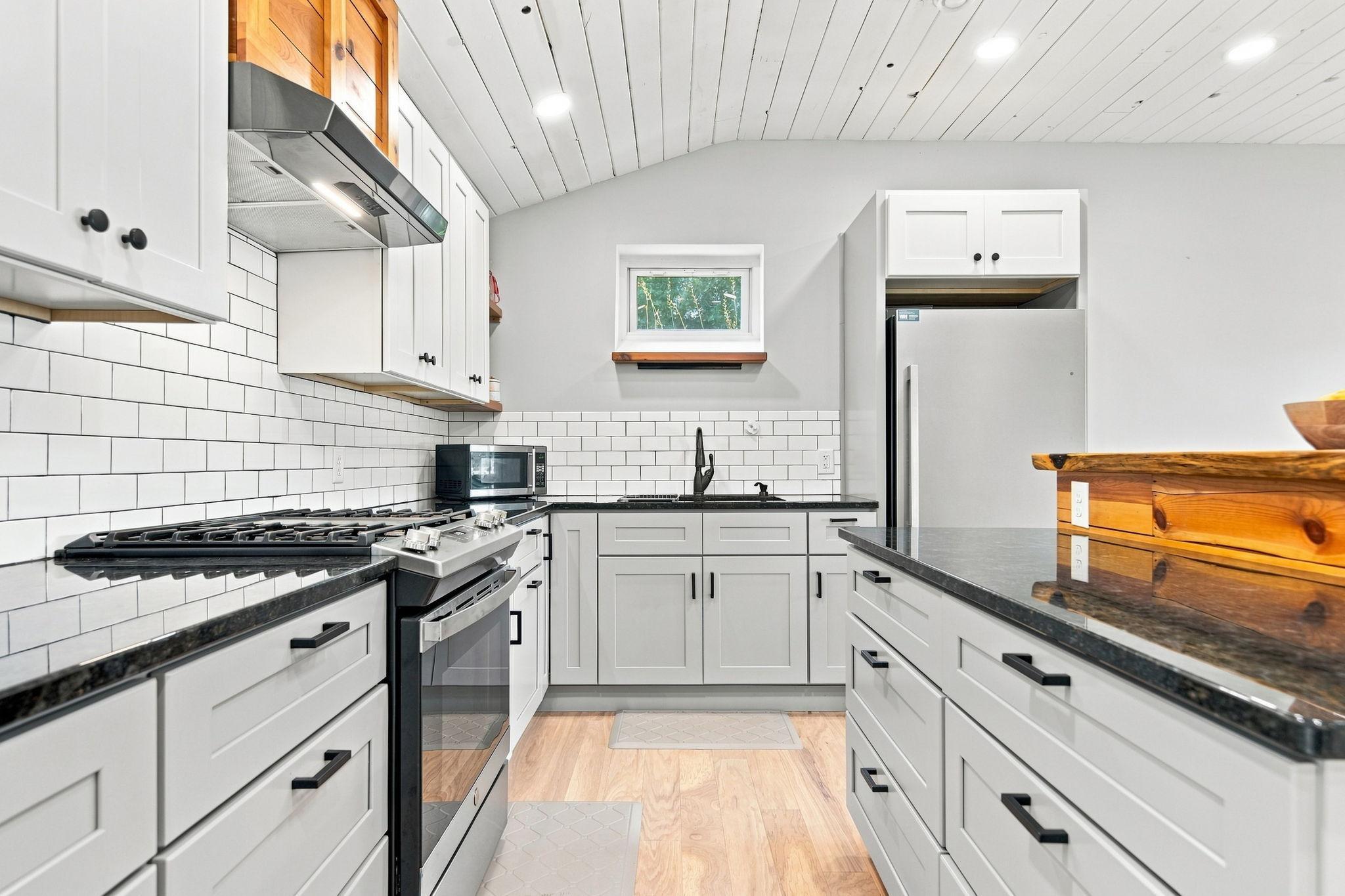 The home features a stainless steel gas range and fridge as well as soft close drawers.
