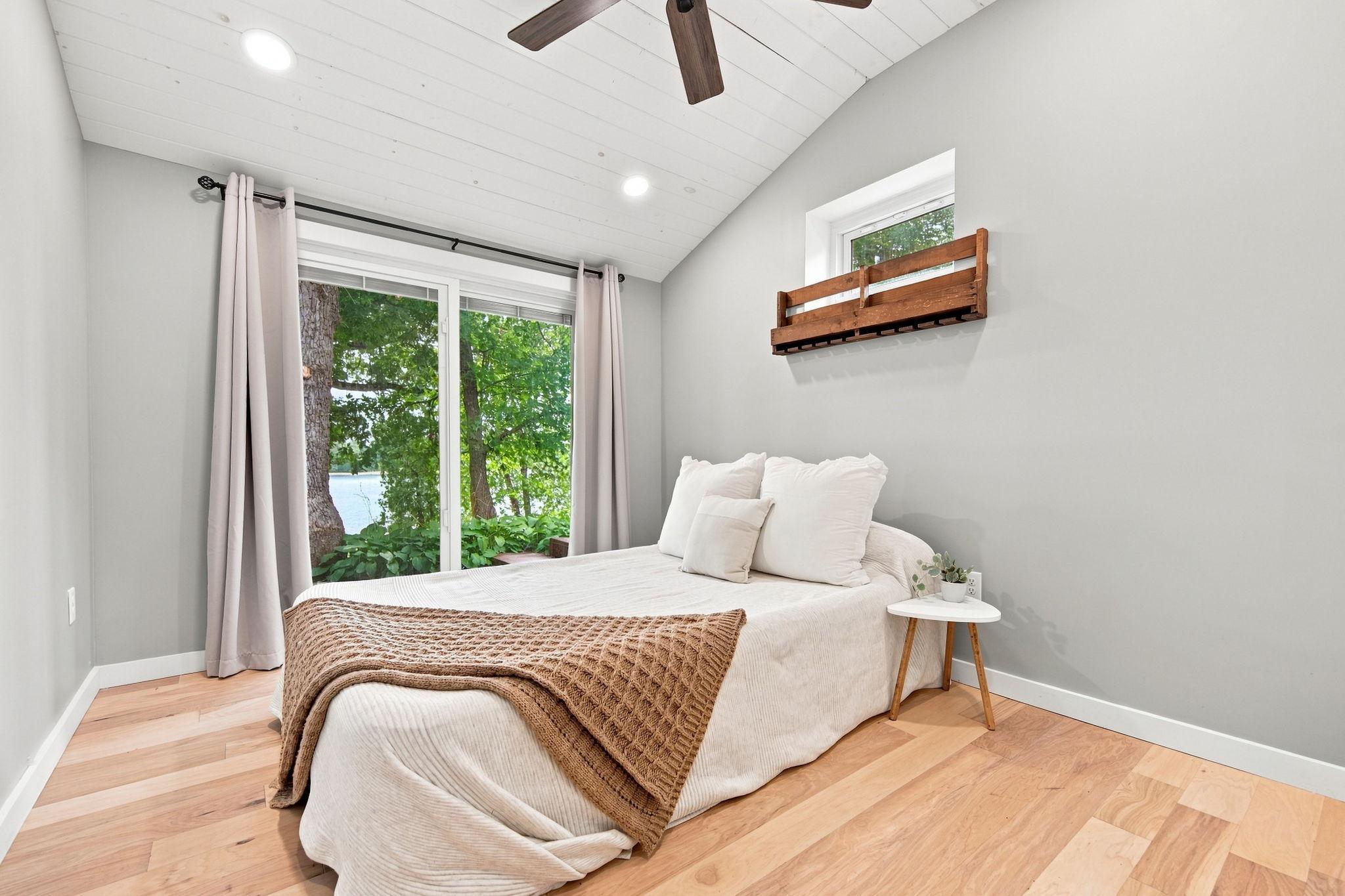 Primary bedroom with walkout to the deck overlooking the lake.