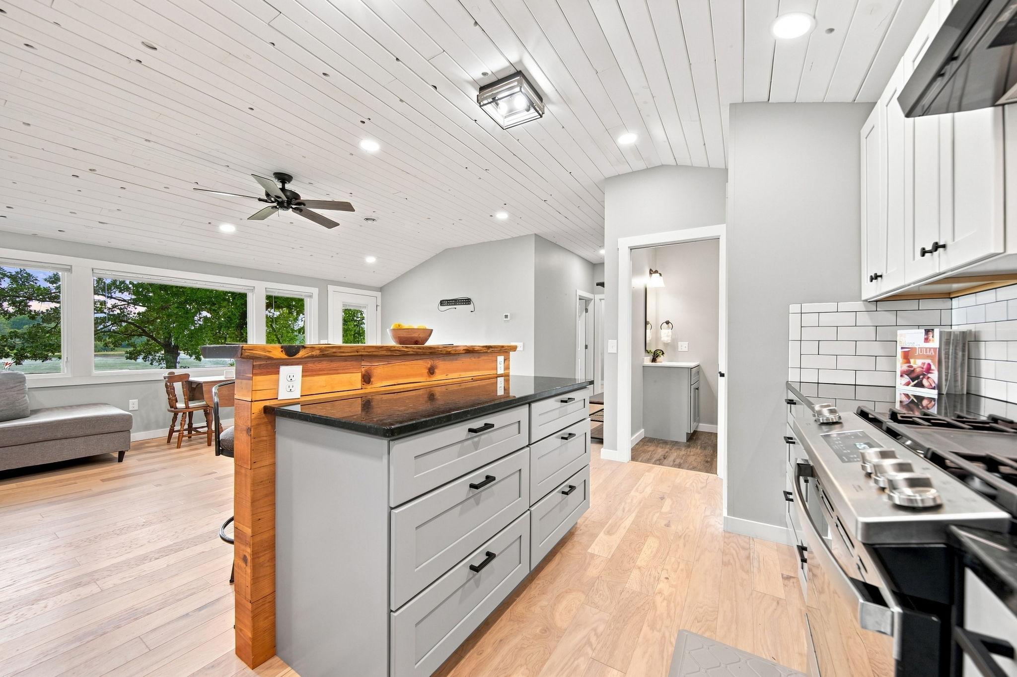 The island creates more counter and prep space. The custom bar top and granite counters are stunning!