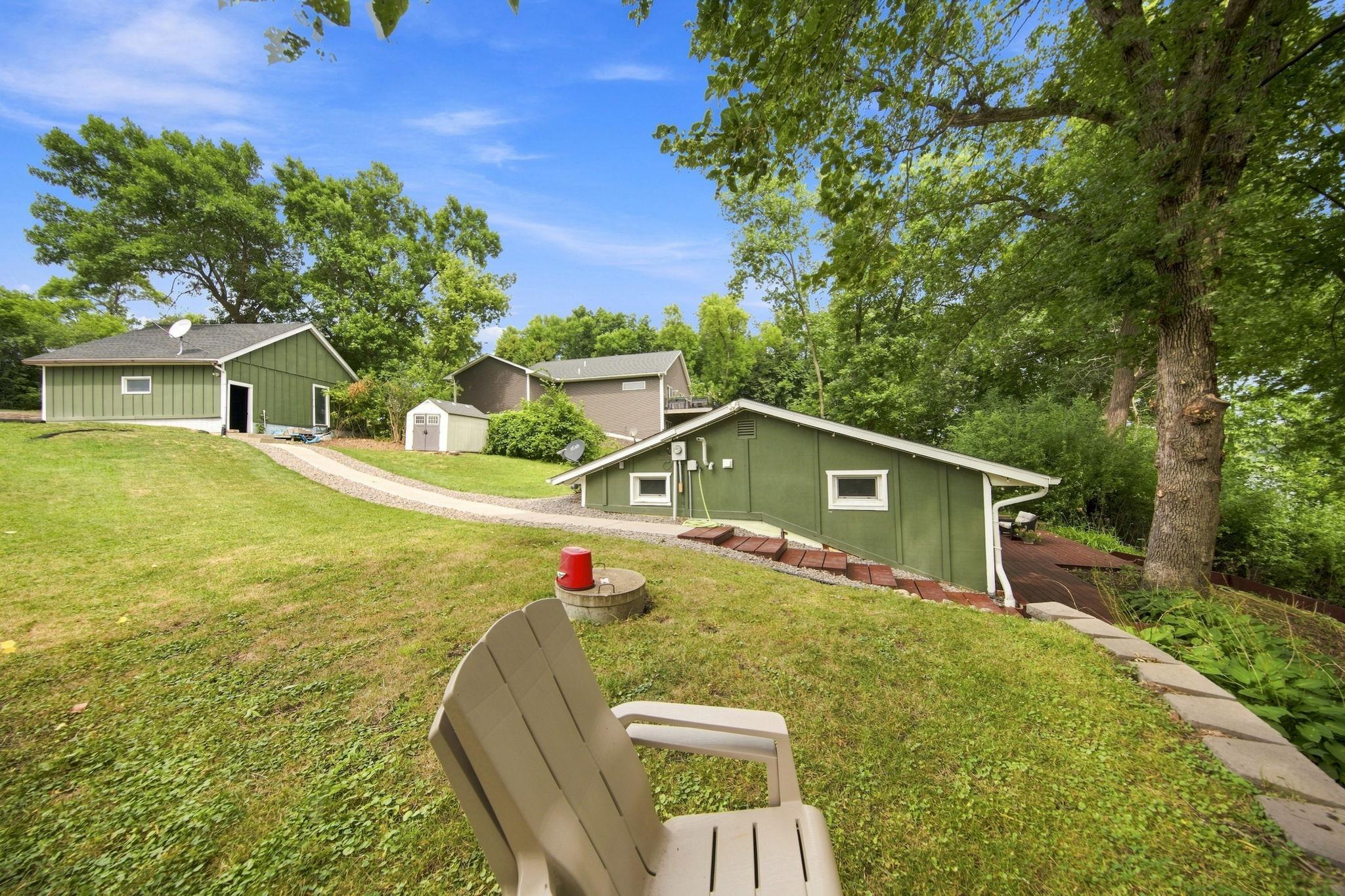 The landscaping is all newer and professionally done! Concrete path from the garage to the steps leading into the home.