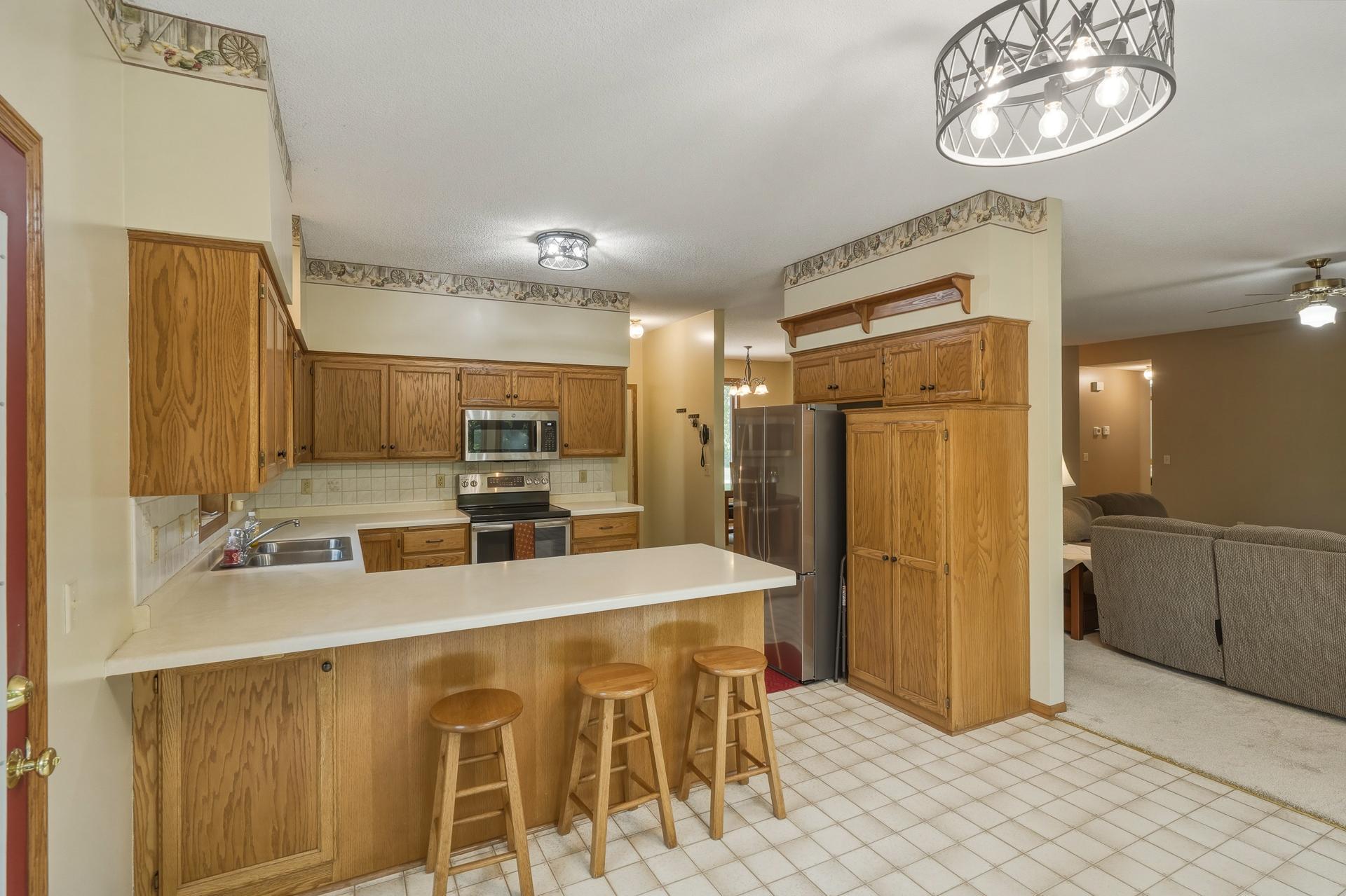 The Kitchen has a Convenient Pantry Cabinet and Breakfast Bar
