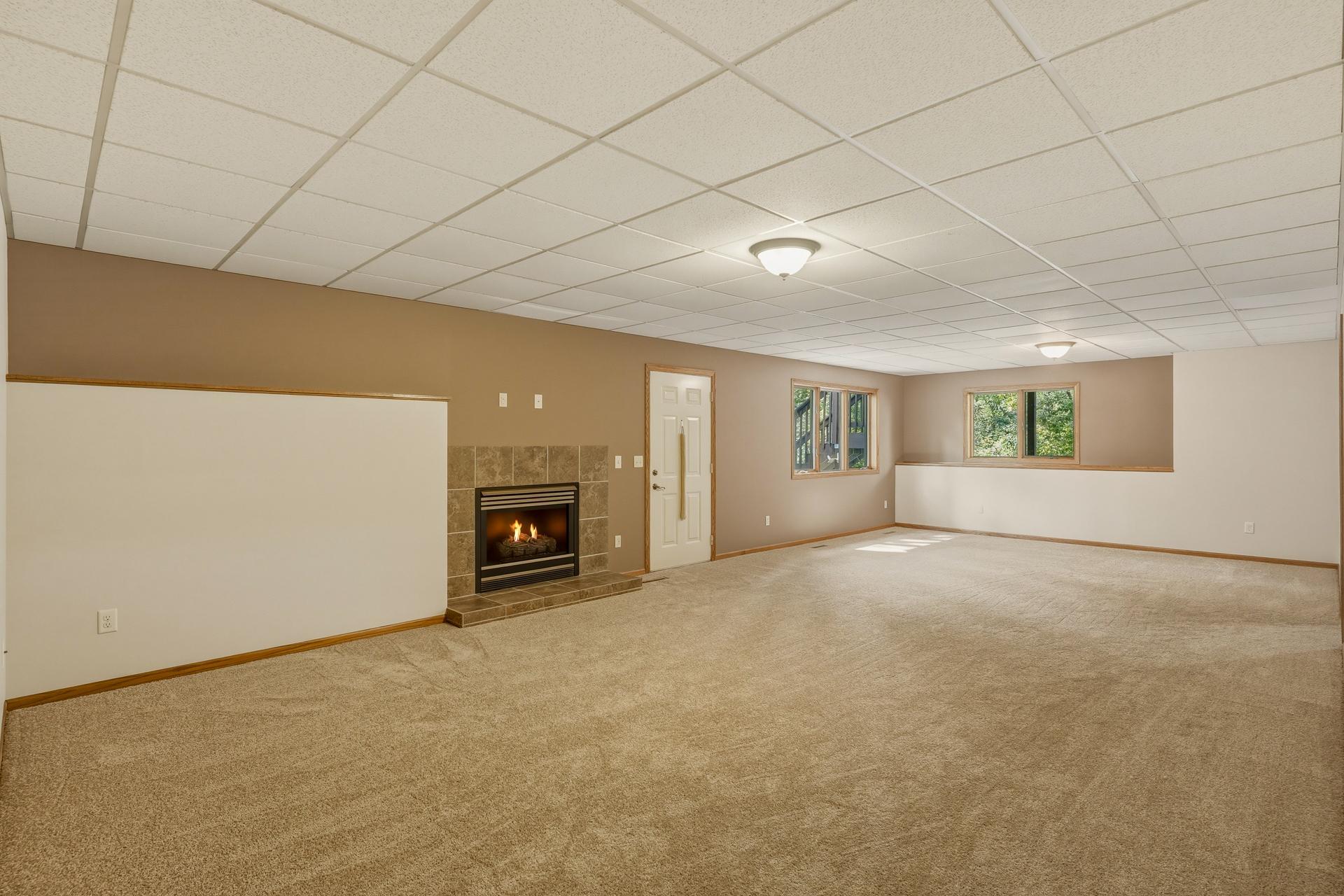 Spacious Lower-level Living Room with a Gas Fireplace. Walk-Out to the Rear Patio