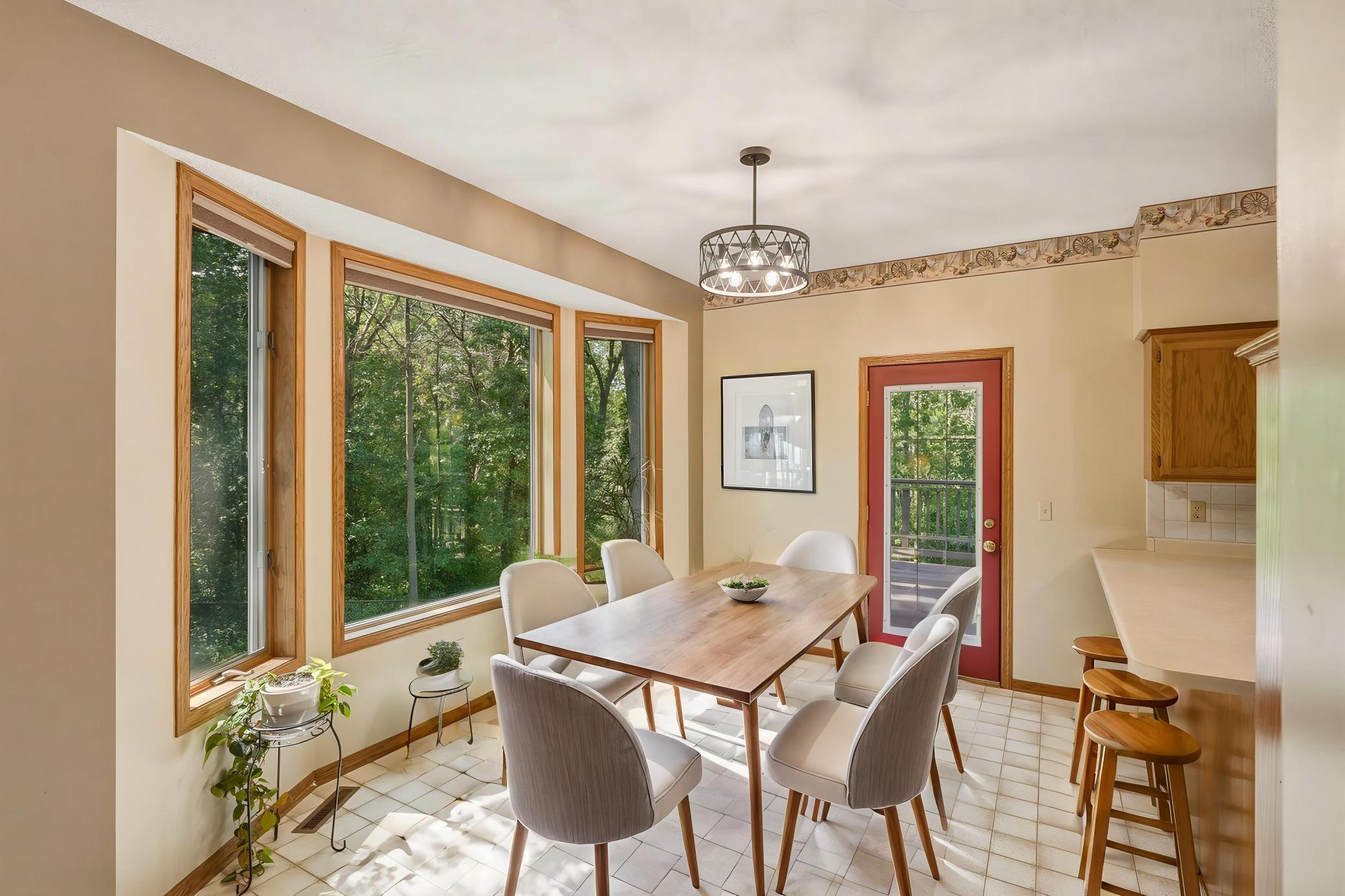 *Virtual Staged Dining Area* The Dining Area is Filled with Natural Light from 3 Windows and Offers Views of the Rear Yard. With Deck Access Just Steps Away, it is an Ideal Spot for Everyday Dining and Entertaining