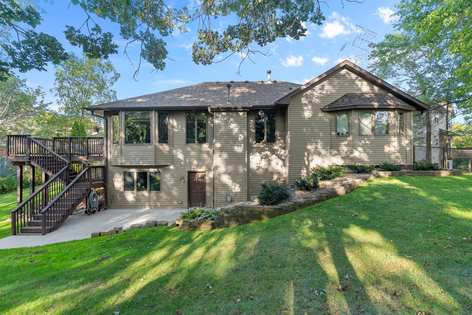 The Walk-Out Lower Level Opens to a Rear Patio and Beautifully Landscaped Backyard, while the Elevated Deck Provides Another Place to Relax and Enjoy the Surrounding Wooded Setting
