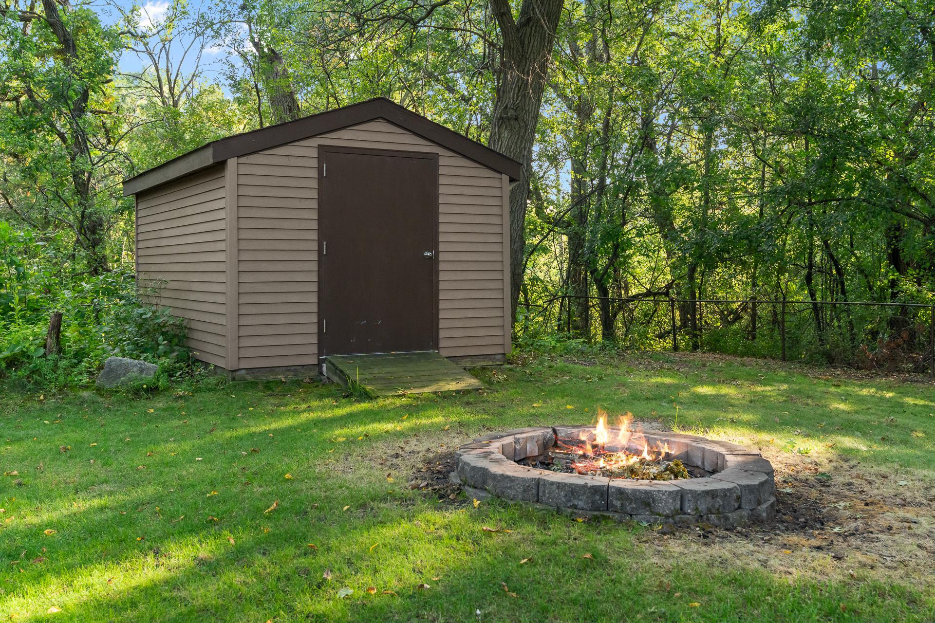 Gather Around the Backyard Firepit and Enjoy the Peaceful Wooded Setting, with a Large Storage Shed Providing Convenient Space for Lawn Equipment, Tools and Outdoor Gear
