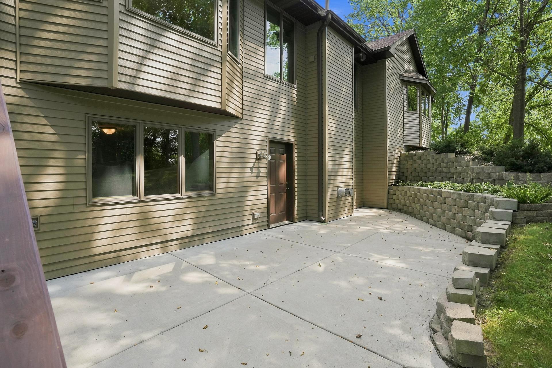 The Walk-Out Lower Level Open Directly to a Spacious Concrete Patio, Creating an Inviting Outdoor Space to Relax