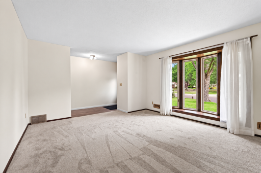 Spacious living room on main level with new carpet