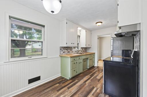 Lots of windows, handy butcherblock countertop and two tone cabinets.