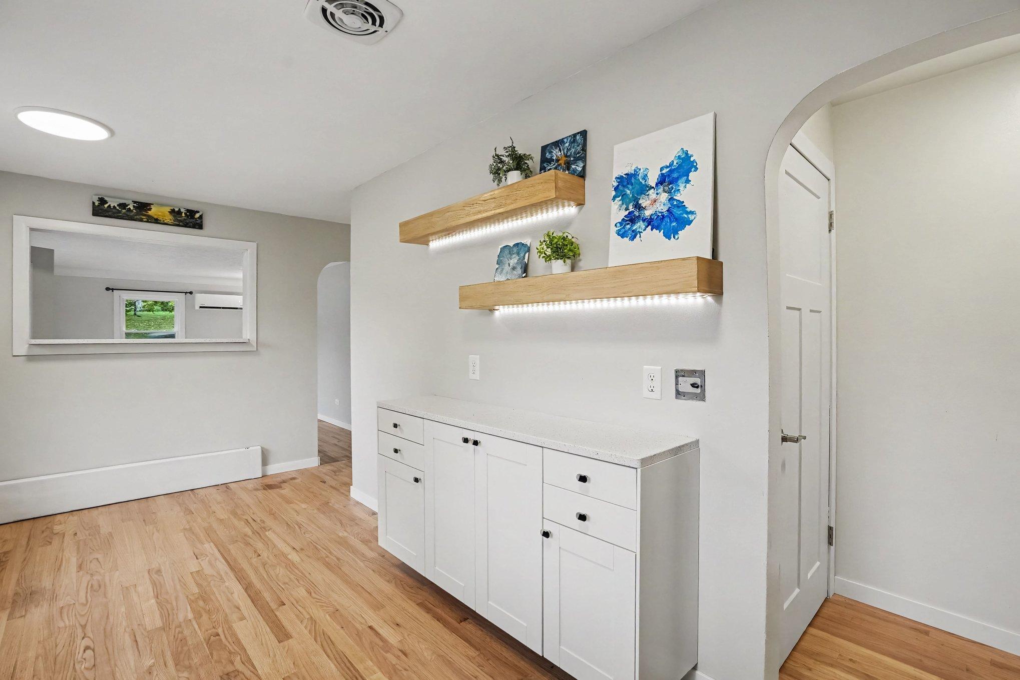 Kitchen has an open wall with quartz countertop into the living room.