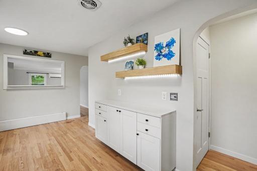 Kitchen has an open wall with quartz countertop into the living room.