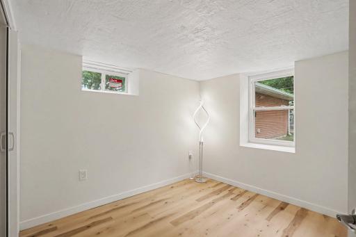Lower Level Bedroom with new floors, windows and trim.