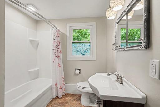 Main Level Bath with new shower surround, window and flooring.