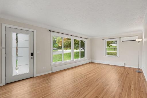 The living room has refinished hardwood floors, new windows and front door to let in extra light.