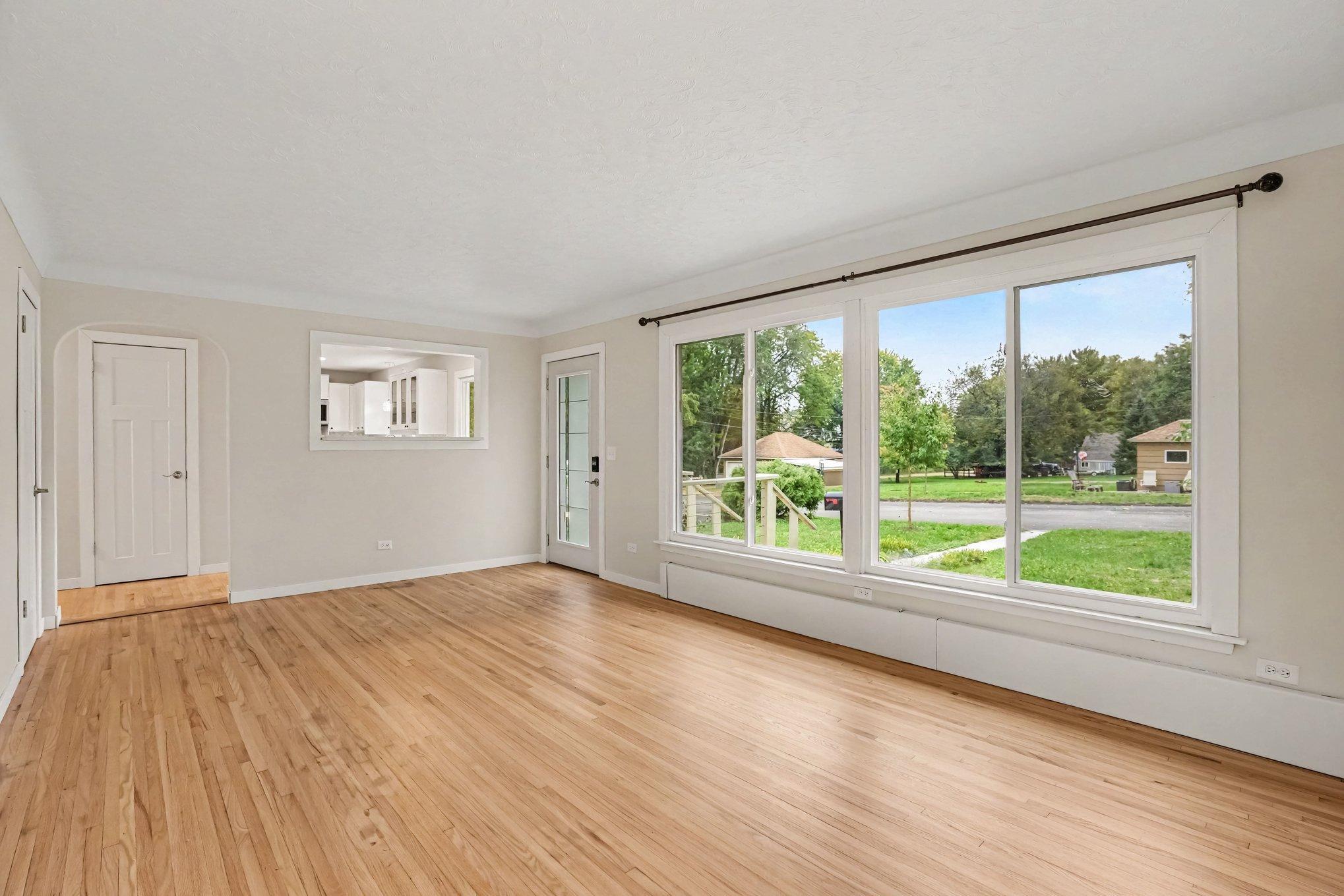 Living room looks into the kitchen and has large front windows for tons of light.