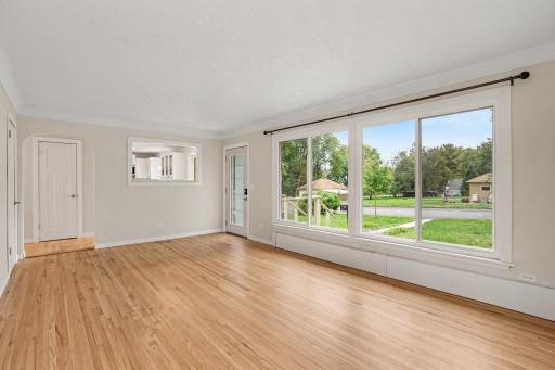 Living room looks into the kitchen and has large front windows for tons of light.