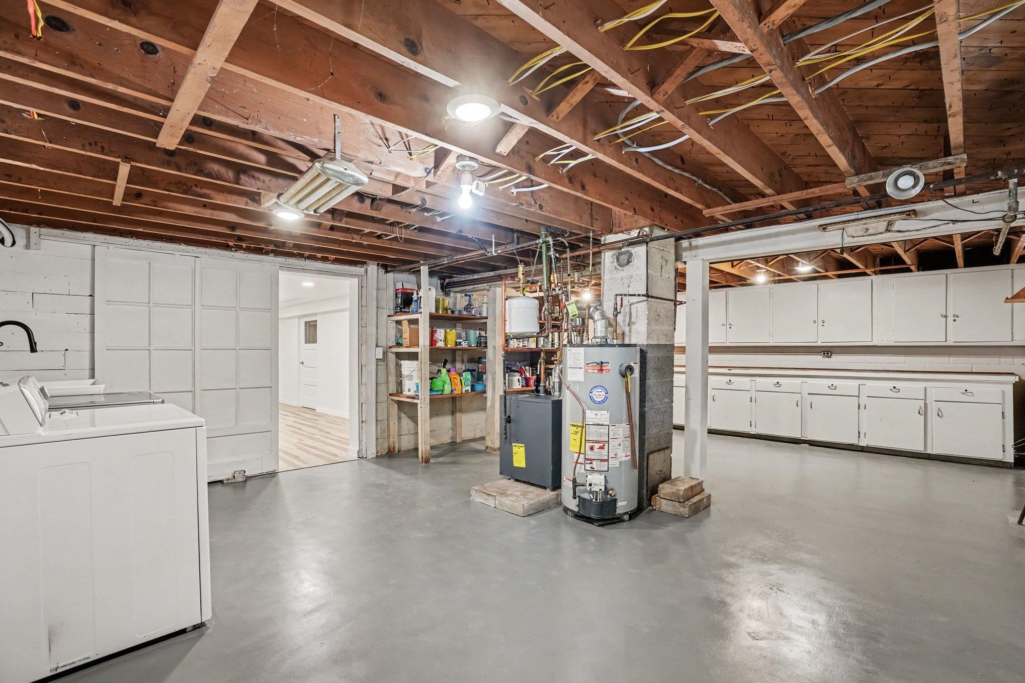 Laundry and tons of work or storage space in this lower level unfinished space.