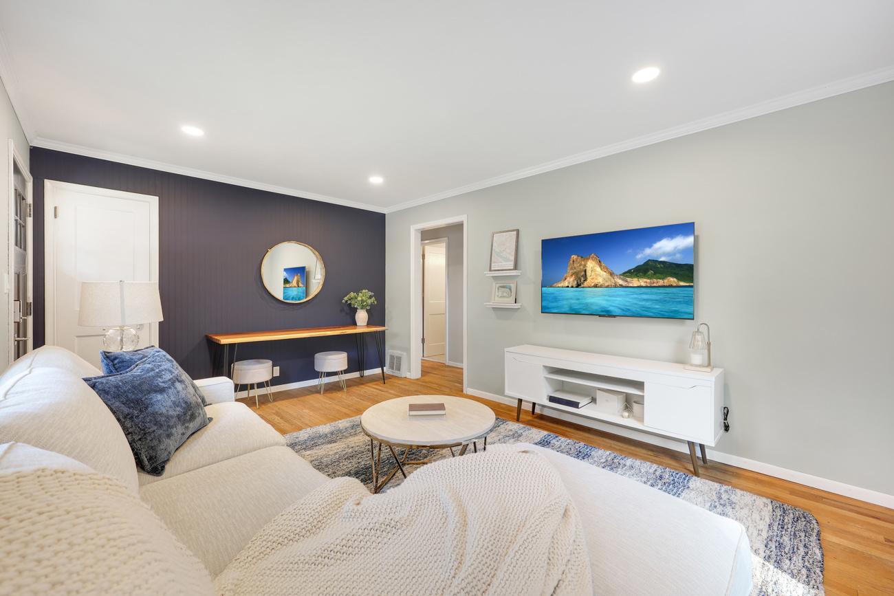 Spacious living room featuring a stylish accent wall and abundant natural light.