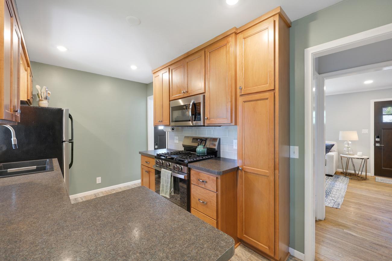 Updated eat-in kitchen with warm wood cabinetry and modern finishes.