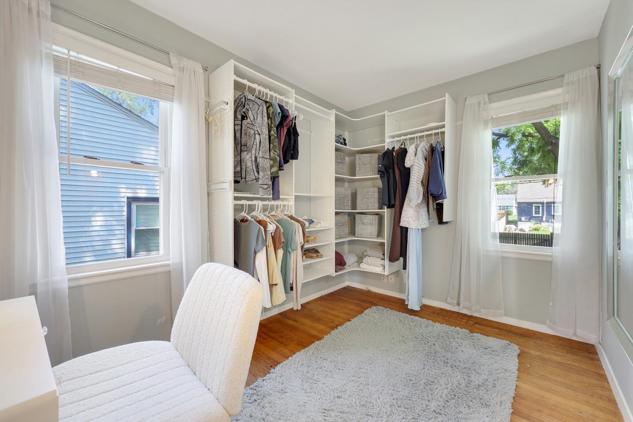 Second main-level bedroom featuring built-in shelves for storage.