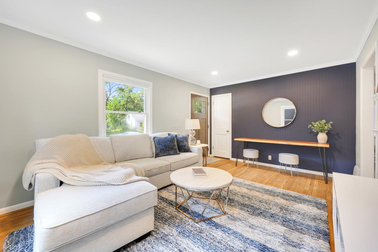 A view of the bright living room with hardwood flooring.