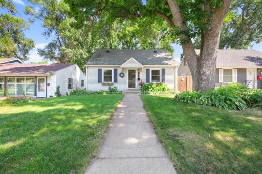 Charming exterior with mature trees and welcoming curb appeal.