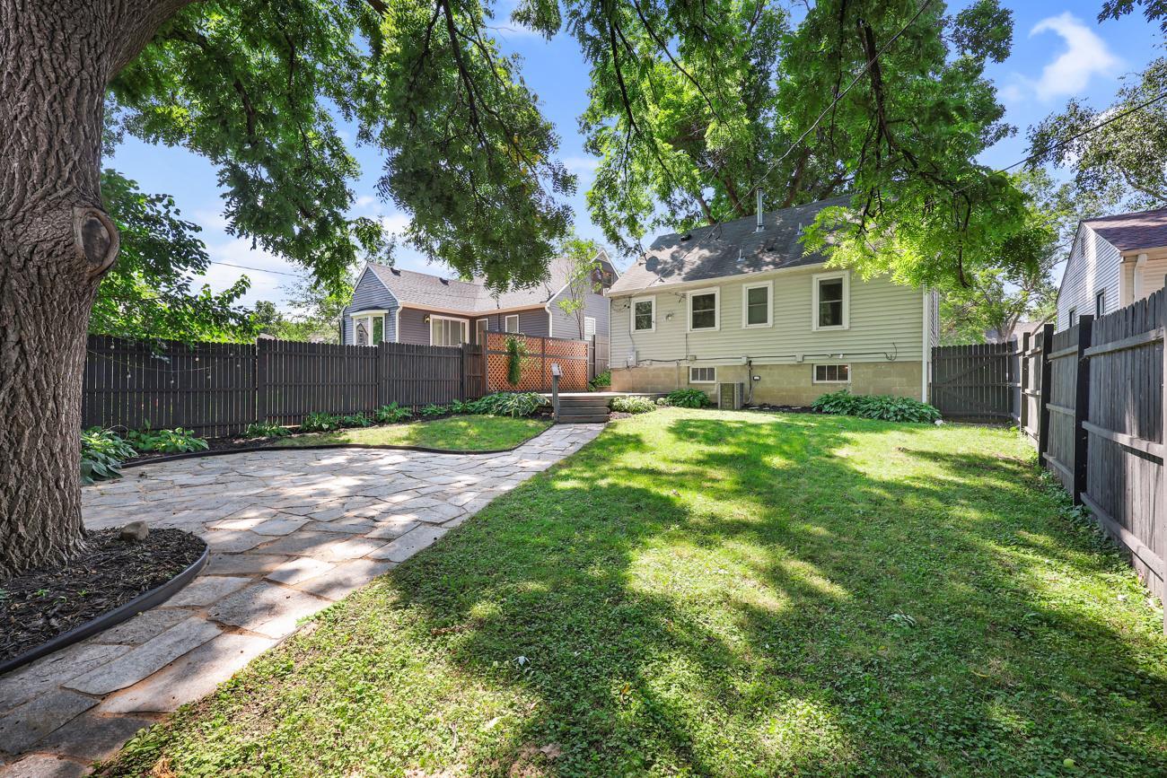 Fully fenced backyard with mature trees and plenty of green space.