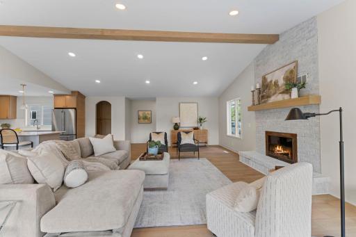 The stunning main level features brand-new LVP flooring and an expansive open-concept design highlighted by 11-ft vaulted ceilings.