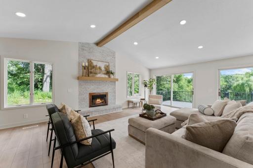 A wood-burning fireplace (nonfunctioning) with a floor-to-ceiling brick surround serves as a warm focal point, adding character and inviting ambiance to the space.