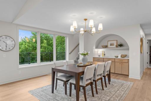 Connected dining space with statement lighting, ideal for daily meals or hosting.