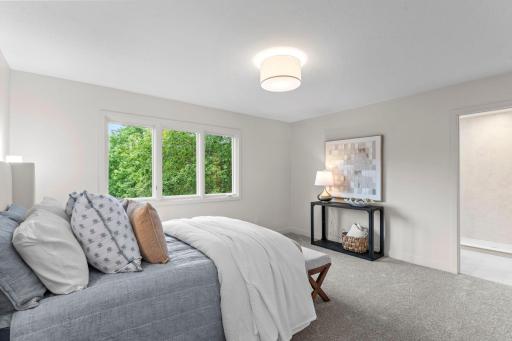 Retreat to the convenient main-level primary suite.