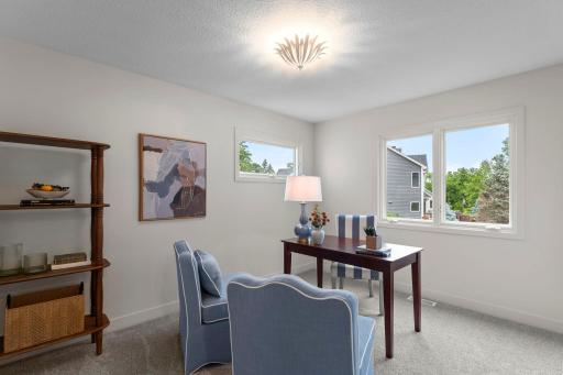 Also located on the main level is a secondary bedroom offering exceptional flexibility to suit a variety of lifestyles. Whether utilized as a private home office, media room, bedroom, or hobby space, this versatile room adapts to many needs.