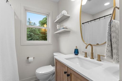 Thoughtfully designed for everyday living, the main level also features an updated full bathroom with a vanity offering convenient storage.