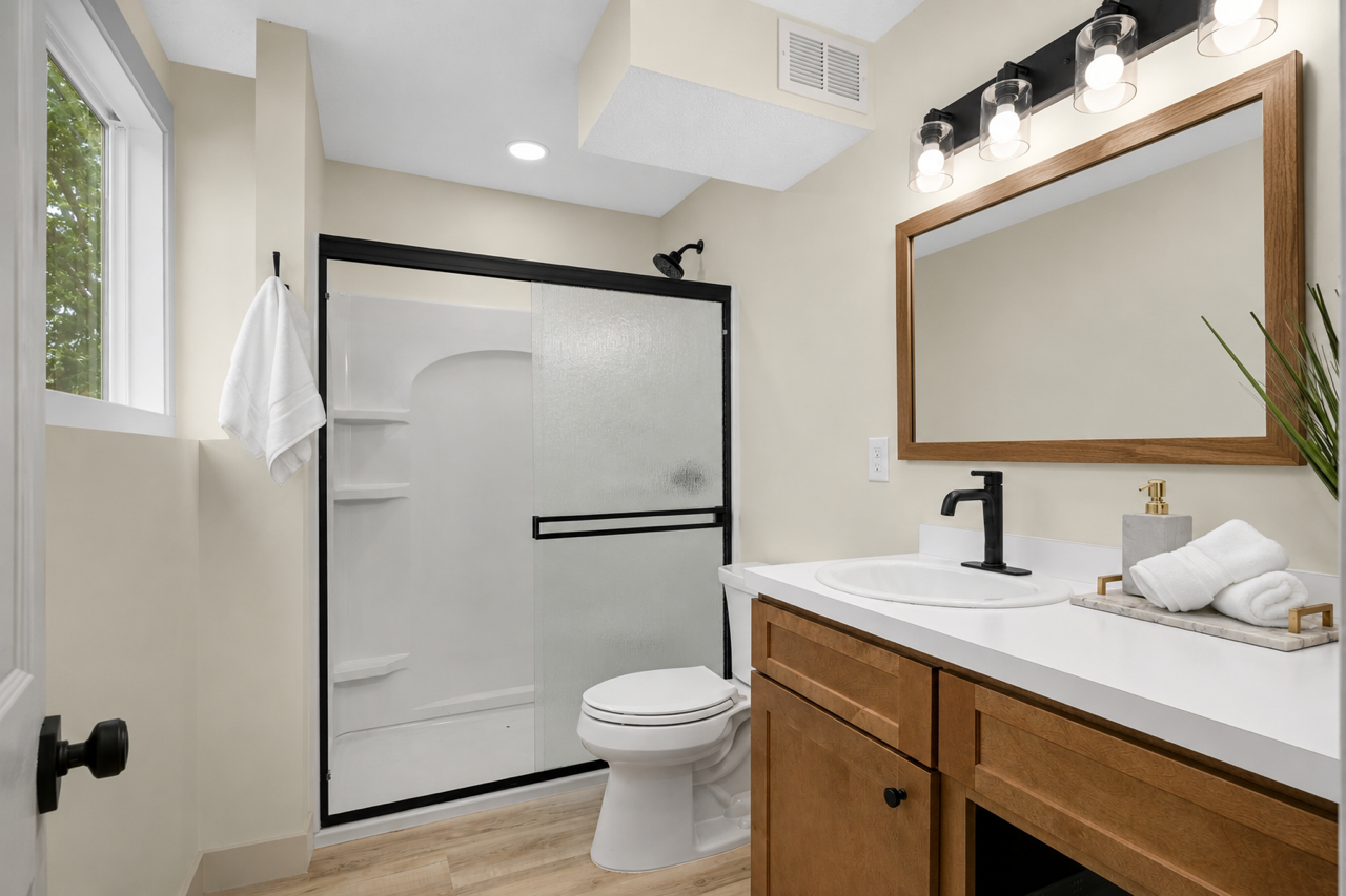 Newly renovated bathroom in lower level flooded with natural light.