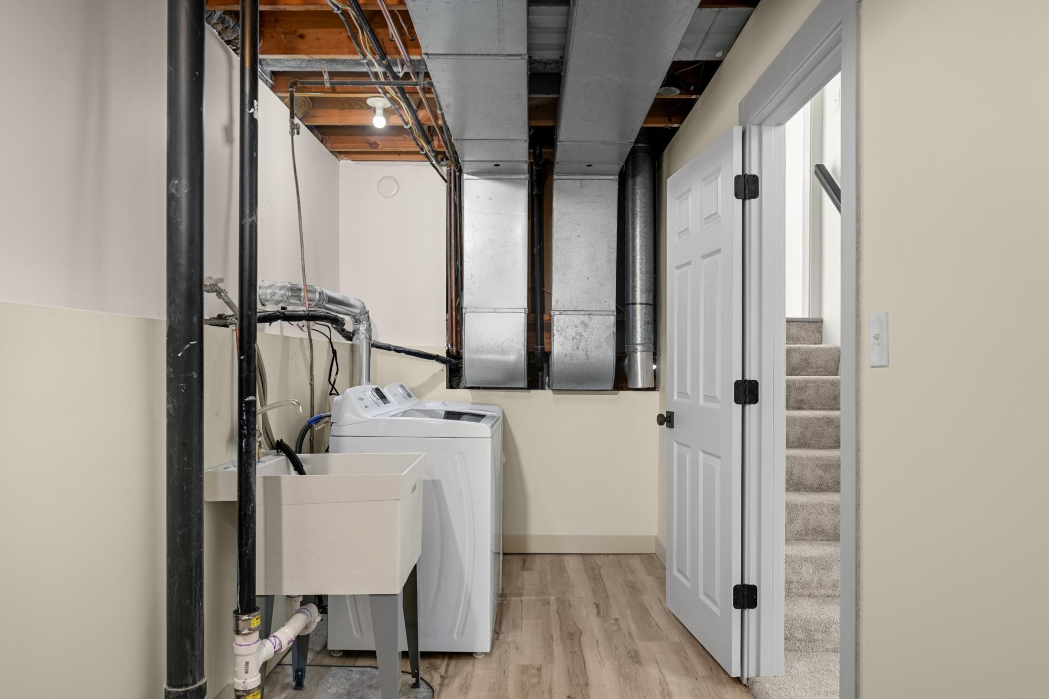 Lower level Laundry and storage room with brand new washer and dryer.