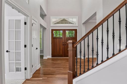 A gracious foyer introduces gorgeous walnut flooring, soaring spaces, and elegant architectural details.