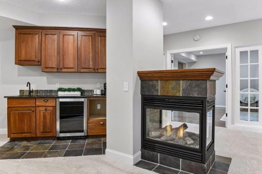 The lower-level kitchenette adds cabinetry, sink and beverage refrigerator, making entertaining and extended stays especially convenient.