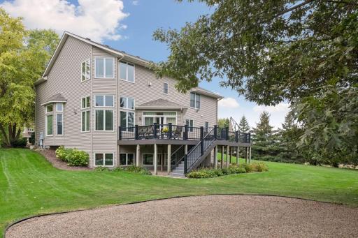 The spacious maintenance-free deck extends the living space outdoors and overlooks a beautifully wooded backyard.