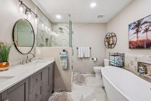 Perfect place to relax in your upper level bath (complete remodel) featuring double vanity, soaking tub and tile shower.