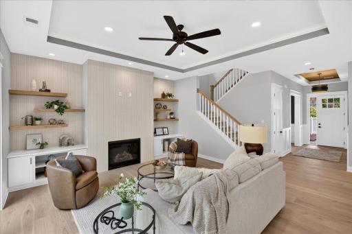Main level family room with gas fireplace and great built-in storage on either side. The neutral finishes go with any decor!