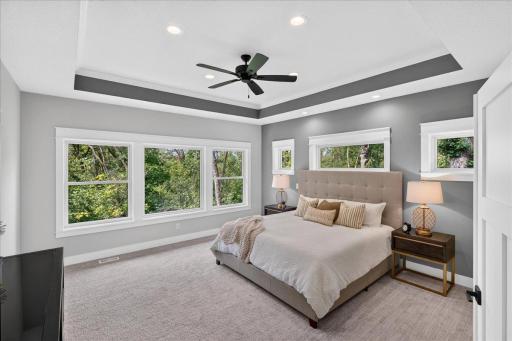This upper level primary bedroom is a must see and features large windows, trayed ceiling with fan, spa-like private bathroom and an insanely huge walk-in closet area!
