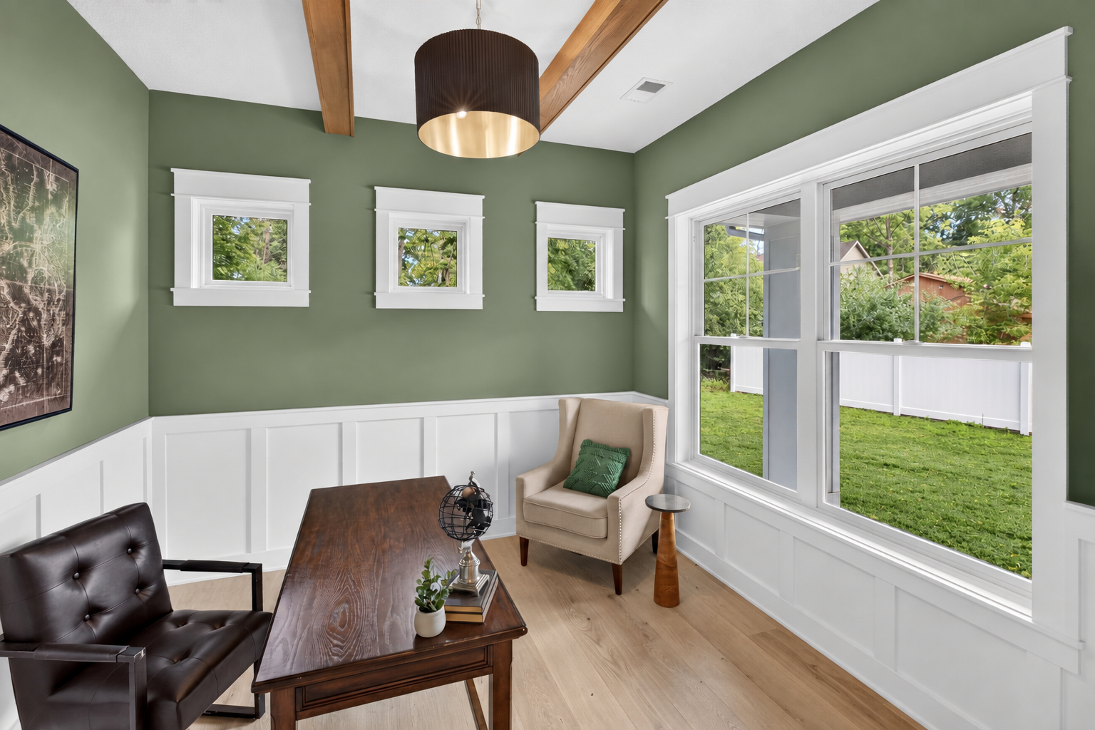Main level office features large windows and decorative wood beams overhead.