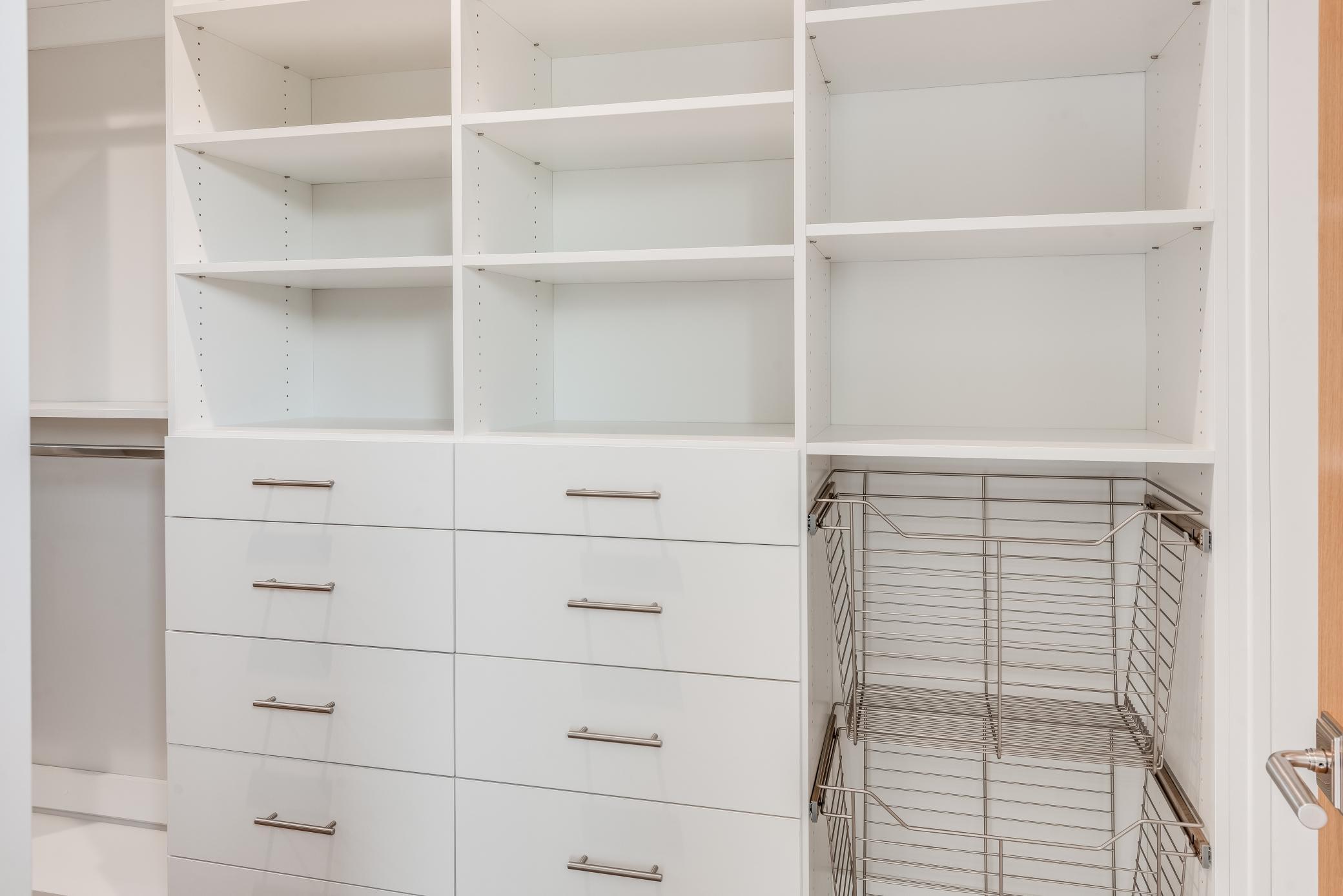 The owner's suite features a large walk in closet with custom shelves