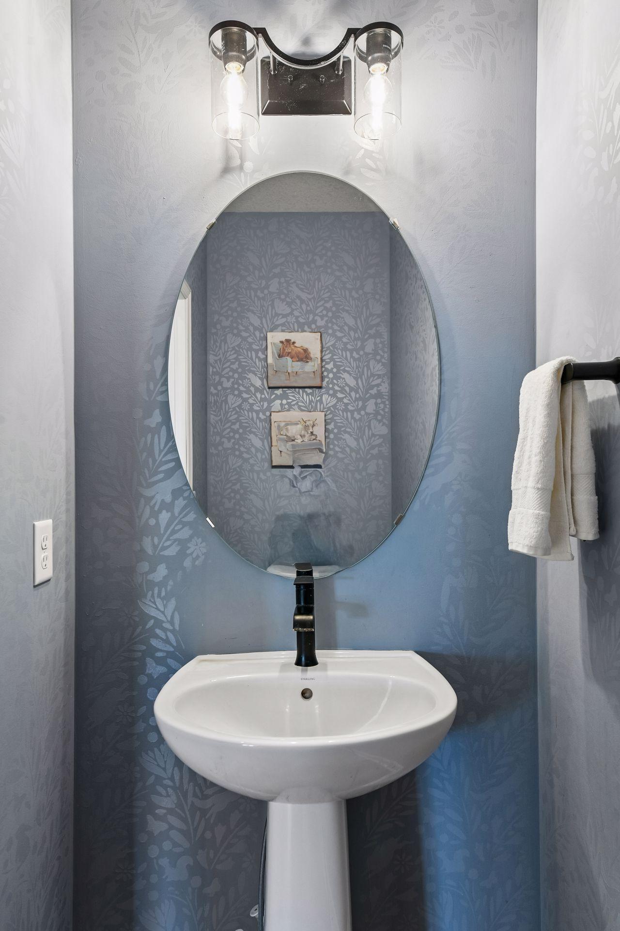 Half bath on main level includes custom stenciled walls