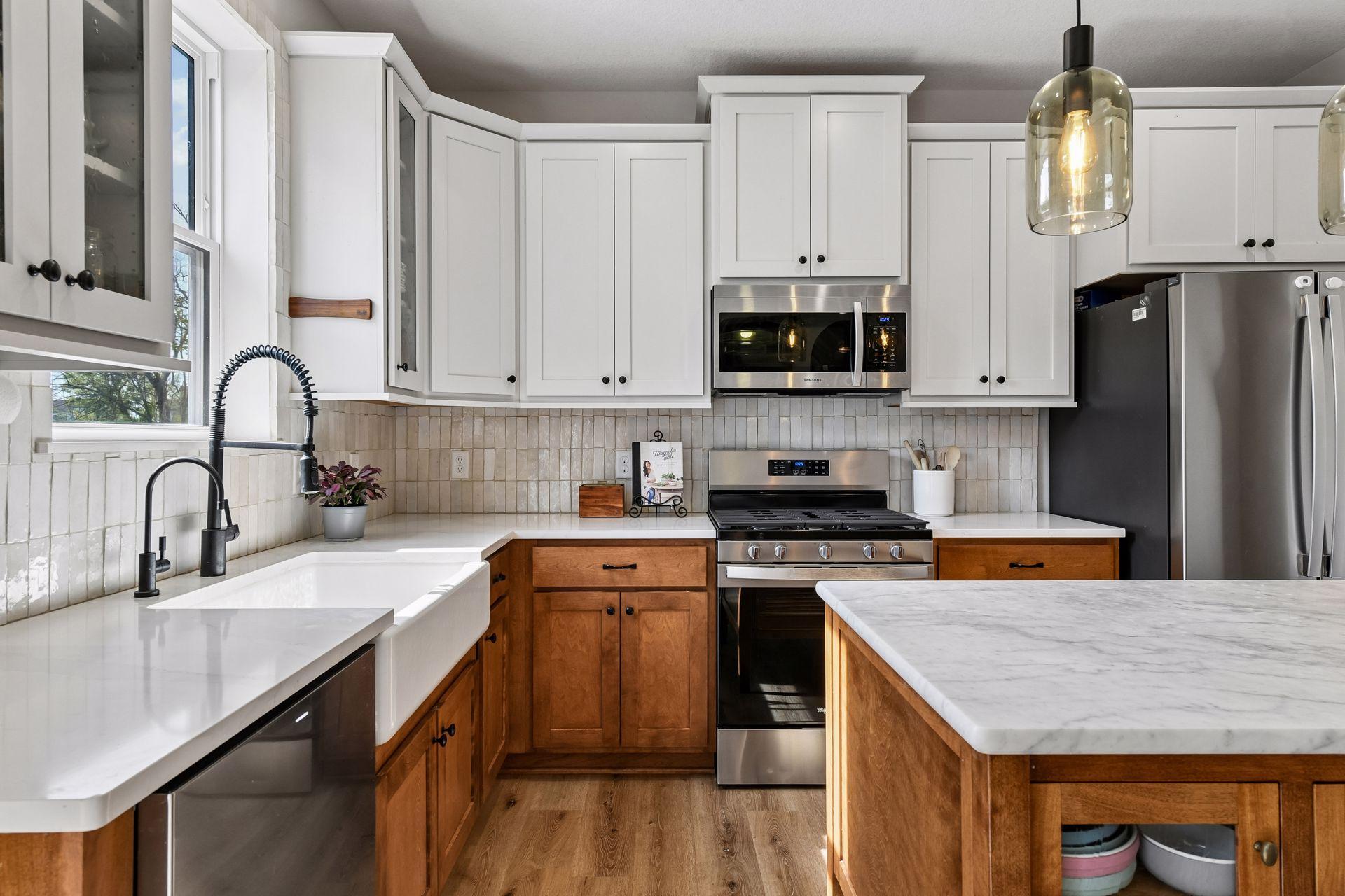 Stainless steel appliances, custom backsplash and warm cabinetry makes this kitchen a 10/10