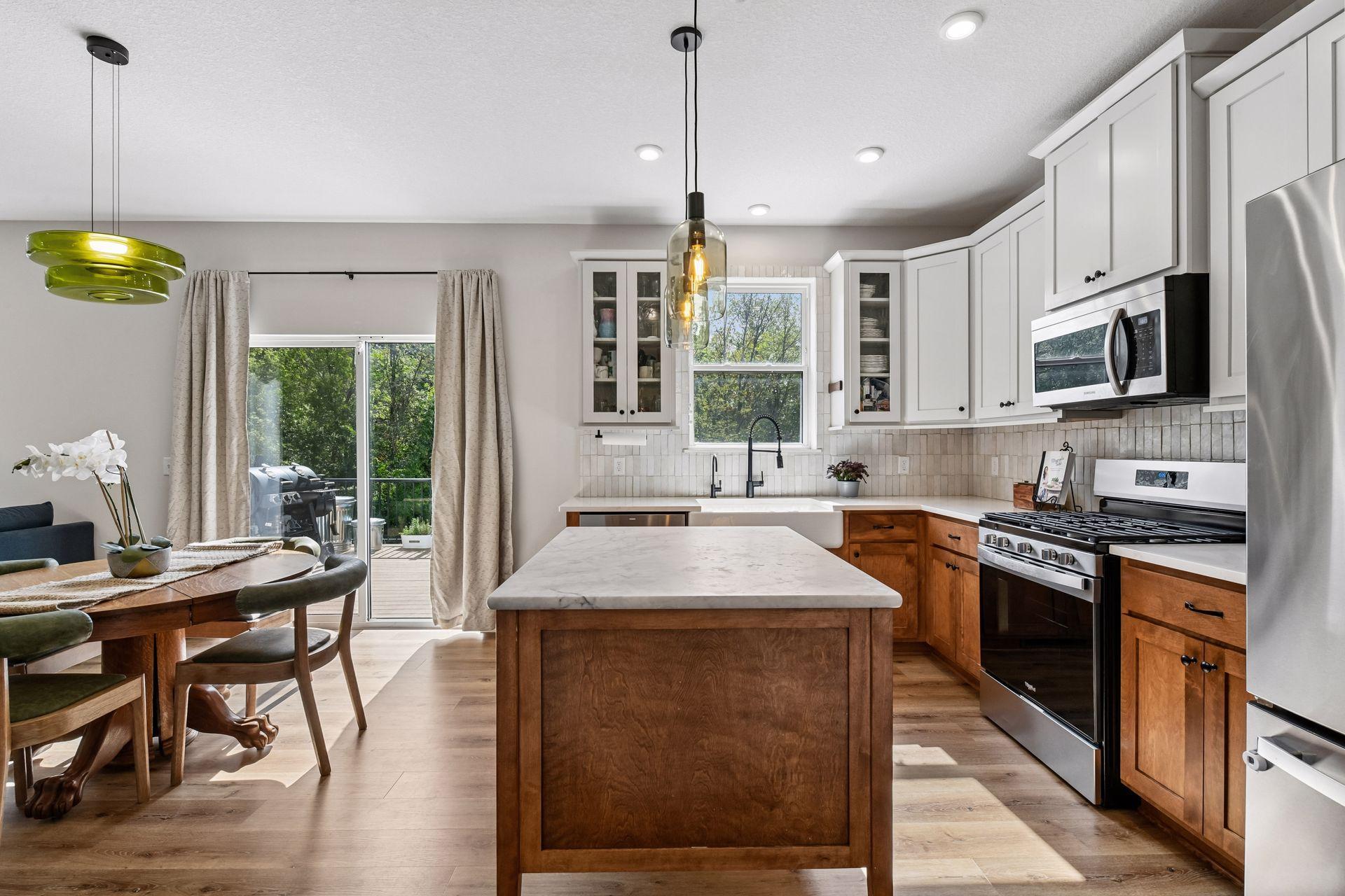 Kitchen with center island, stainless appliances, and access to rear patio door