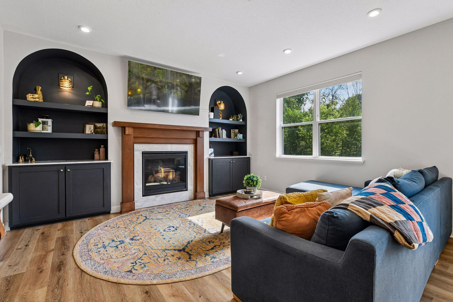 As you enter in the home you are greeted with custom built in's flanking gas fireplace